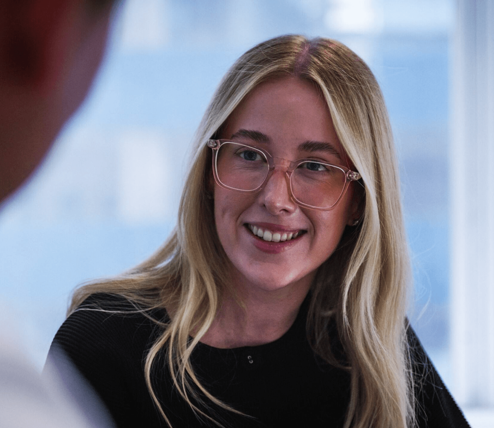 LAB3 team member smiling in a bright office setting